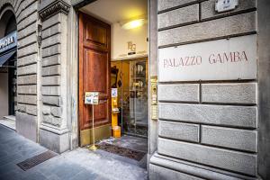 a building with a sign on the door of it at Palazzo Gamba Apartments al Duomo in Florence