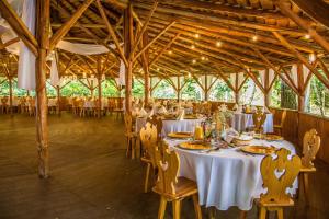 a dining room with white tables and chairs at Jodełka in Święta Katarzyna