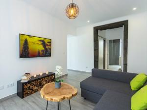 a living room with a couch and a table at Castanheiro in Lagoa