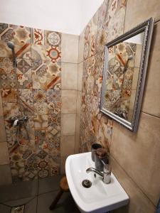 a bathroom with a sink and a mirror at Őrség Kincse in Hegyhátszentjakab