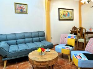 a living room with a blue couch and chairs at Achi's House in Lefkada