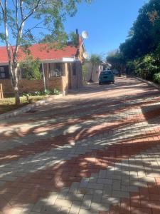 a brick road in front of a house at Cycad Stay in Mthatha