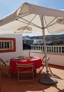 a table and chairs under an umbrella on a balcony at CASA TAYRI DE TAMAIDE TENERIFE SUR in San Miguel de Abona