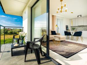 a living room and dining room with a view of a kitchen at Blu Port in Gąski