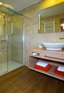 a bathroom with a sink and a shower at Landgasthof Lusenblick in Grafenau