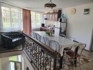 a kitchen and dining room with a table and chairs at Casa Destinatia Perfecta Moieciu in Moieciu de Jos