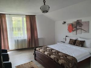 a bedroom with a bed and a large window at Casa Destinatia Perfecta in Braşov +30 photos