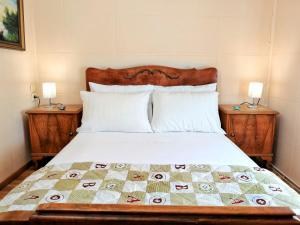 a bedroom with a bed with two nightstands and two lamps at Achi's House in Lefkada +31 photos