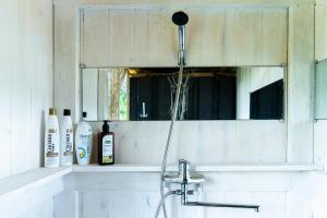 a bathroom sink with a faucet and a mirror at Rouna Family Home in Ainja +34 photos