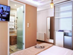 a bathroom with a glass door leading to a shower at Achi's House in Lefkada