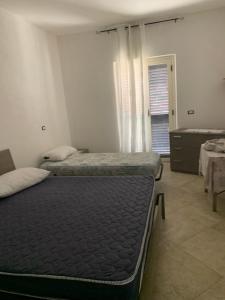 Un pat sau paturi într-o cameră la B&B nonna Rosaria