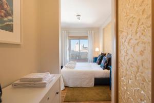 a small bedroom with a bed and a window at BBA Apartments Boavista - Casa da Música with Parking in Porto