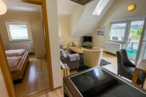 a room with a living room and a dining room at Kimi's House - FeWo in Burg an der Mosel