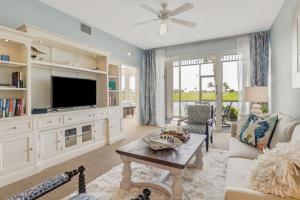 a living room with a tv and a couch and a table at Lely-Best of Beautiful Naples Free golf from May 15-October 15 in Naples