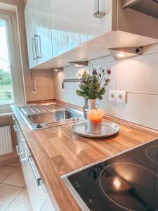 a kitchen with a sink and a candle on a counter at Grüntenblick in Kempten