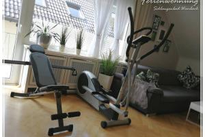 a living room with a couch and a gym at Schöne 4-Zimmerwohnung, Schlangenbad bei Wiesbaden/Mainz/FFM in Schlangenbad