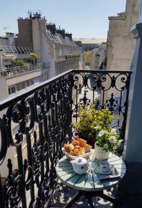 a plate of food on a table on a balcony at HOTEL ALISON in Paris