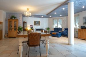 a kitchen and living room with a table and chairs at Villa Miriam in Levico Terme