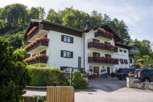 a large white building with flowers on the balconies at Gästehaus Schreyer in Oberaudorf