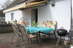 a table and chairs with a bbq and a grill at Isi-Hof 