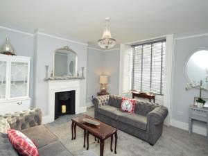a living room with a couch and a fireplace at Tavistock Town House in Tavistock
