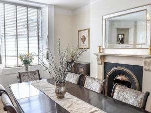 a dining room with a table and a fireplace at Tavistock Town House in Tavistock