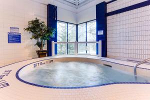 a large hot tub in a room with a window at Park Town Hotel in Saskatoon