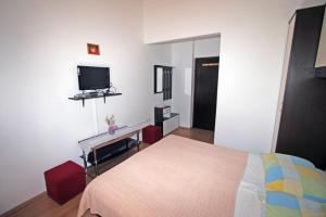 a bedroom with a bed and a flat screen tv at Room in Medulin with terrace, air conditioning, WiFi 3488-6 in Medulin