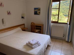 Un pat sau paturi într-o cameră la Apparthotel Le Porto