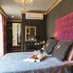 a bed room with a large bed and a painting on the wall at Julina Boutique Living in Mosta