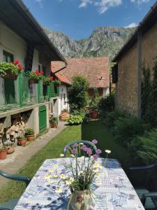 a table with a vase of flowers on it at Kristaly vendeghaz in Rimetea