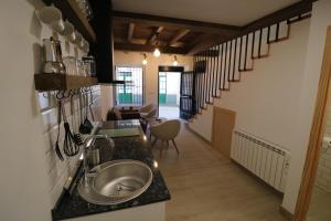a kitchen with a sink and a living room at Buen Camino Melide in Melide