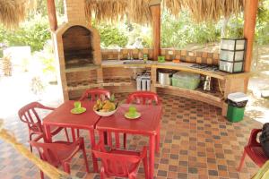 a patio with a table and chairs and a kitchen at Finca de Nosotros in Bonda
