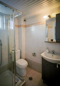 a bathroom with a toilet and a sink at Yria ntn Studios in Vanáton +25 photos
