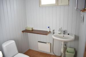 a white bathroom with a sink and a toilet at Karjalan Helmi in Tolosenmäki +51 photos
