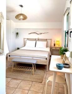 a bedroom with a bed and a table at Seafront Maisonette in Pefkohori