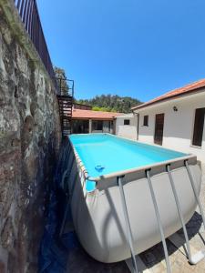 a swimming pool in the backyard of a house at Casa da Viela in Arouca