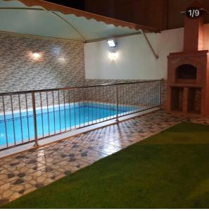 a swimming pool in a building with a balcony at شاليهات شاطئ ارينا in Qarār