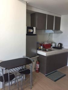 a small kitchen with a sink and a table at Mplace Condo Unit _ Panay Avenue, Quezon City, Philippines in Manila