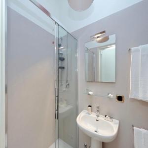 a bathroom with a shower and a sink and a mirror at Fontana Più Stella in Rome
