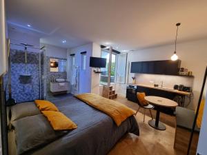 a bedroom with a large bed and a bathroom at La chambre des secrets in Biarritz