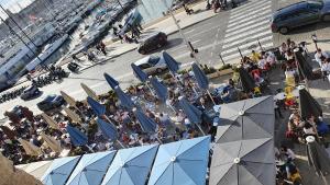 an overhead view of a crowd of people sitting at tables at Grand Loft en plein coeur du Vieux-Port in Marseille