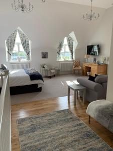 a bedroom with a bed and a living room at Greystones in Cardiff