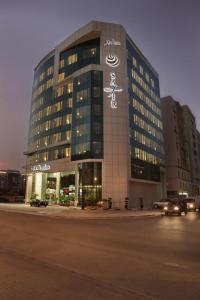 a large building with writing on the side of it at Safir Hotel Doha in Doha