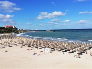 a bunch of umbrellas and chairs on a beach at Studio Callatis Central - adults only in Mangalia