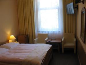 Łóżko lub łóżka w pokoju w obiekcie Hotel Alga