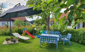 a table and chairs and an umbrella in a yard at Haus Heidi in Freyung