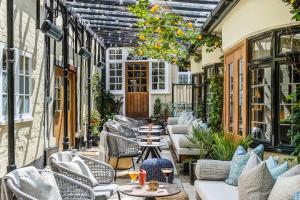an outdoor patio with tables and chairs at The George Hotel in Colchester