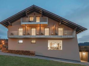 a house with a balcony on the side of it at Winterfeld Guest House Bodenmais in Bodenmais