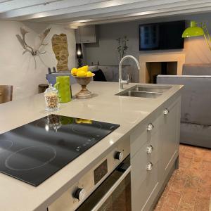 a kitchen with a sink and a counter at Box Barn - Stylish Accommodation in Rutland in Uppingham